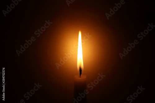 Burning candle in the dark. Сandlelight.