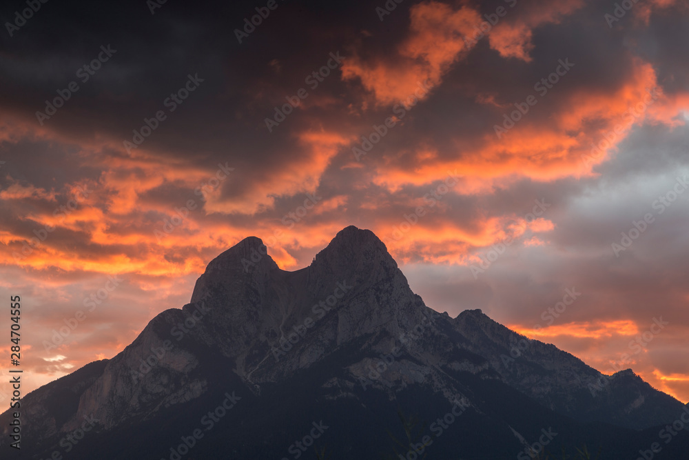 Mountain silhouette in the orange dusk.