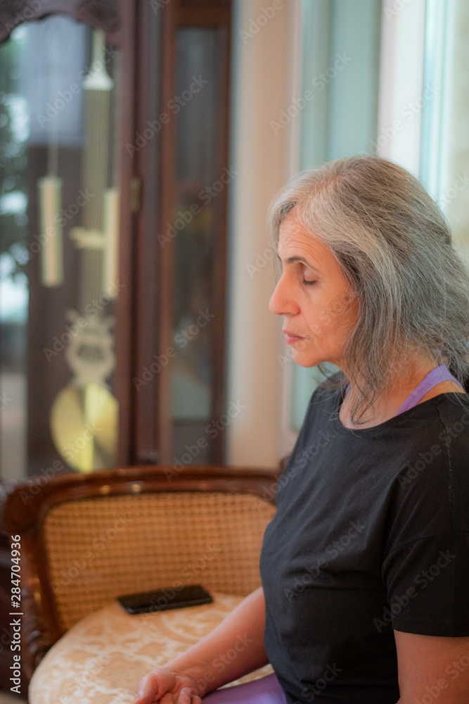 Senior Indian woman with grey hair and glowing skin, meditating in the  morning. Stock Photo | Adobe Stock