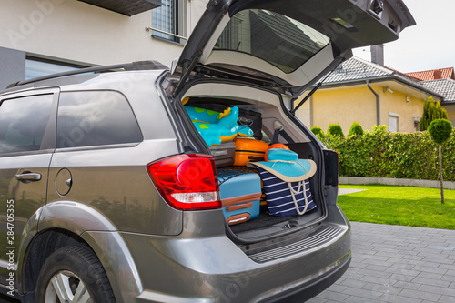 Baggages in the car trunk packed and ready to go for holidays