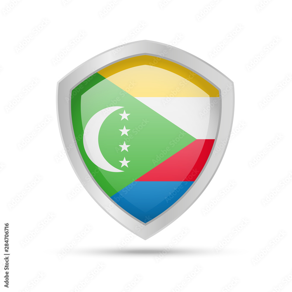 Fototapeta premium Shield with Comoros flag on white background. Vector illustration.
