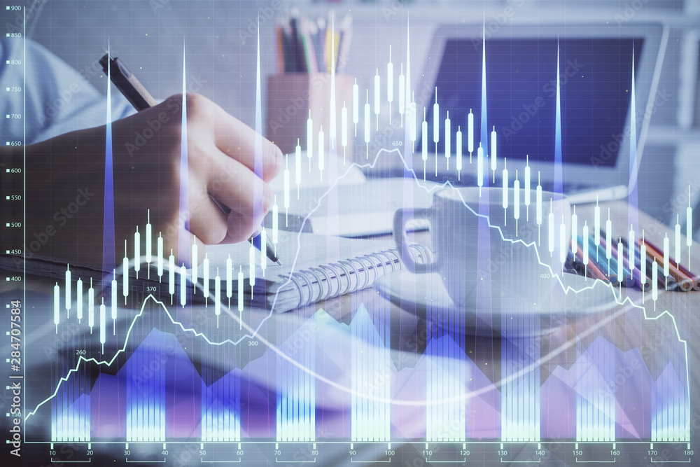 Financial chart drawn over hands taking notes background. Concept of research. Double exposure Financial chart drawn over hands taking notes background. Concept of research. Double exposure
