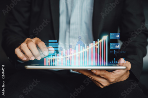 Businessman investment consultant analyzing company financial report balance statement working with digital augmented reality graphics. Concept for business, economy and marketing. 3D illustration.