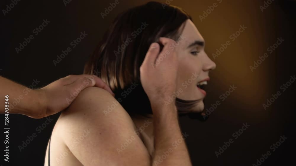 Male touching person in dress looking for woman, but trans man turning to camera Male touching person in dress looking for woman, but trans man turning to camera