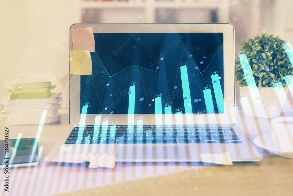Financial market graph hologram and personal computer on background. Multi exposure. Concept of forex. Financial market graph hologram and personal computer on background. Multi exposure. Concept of forex.