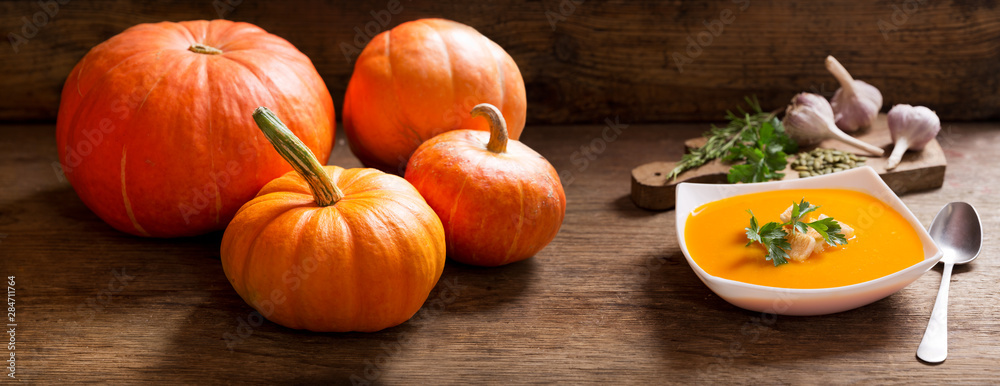 bowl of pumpkin soup with ingredients for cooking bowl of pumpkin soup with ingredients for cooking