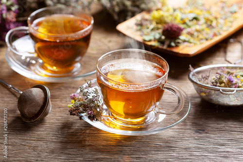 Cups of herbal tea with various herbs