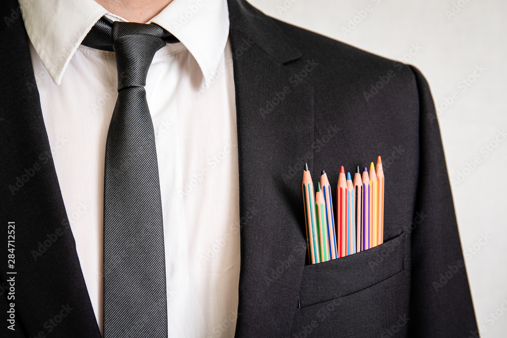 Man in a suit with pencils in front pocket. Business, office, skill, education and back to school concept - obrazy, fototapety, plakaty 