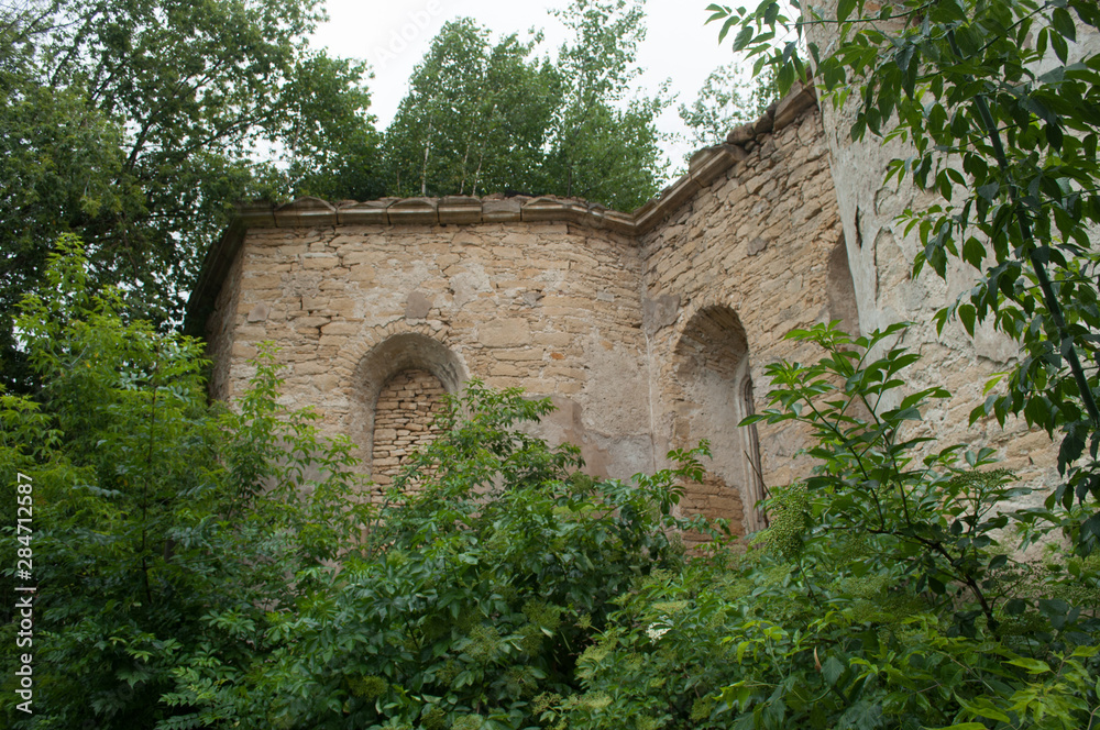 Walls of old abandoned ruined roman catholic church in the village