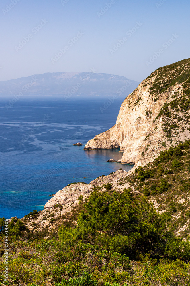 View over the cliffs and the blue sea in the northwest of Zakynthos to the island Kefalonia, Greece