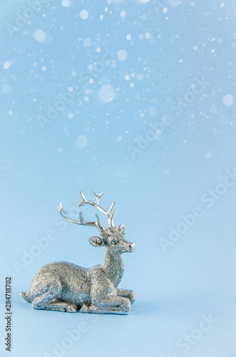 New Year's background. silver deer on a blue background. © iloli