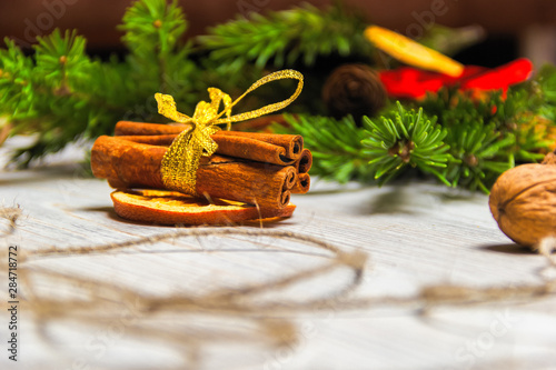 Christmas and New Year composition. Pine branches, cinnamon sticks, dried slices of orange and walnuts. Christmas and New Year concept. Flat lay.