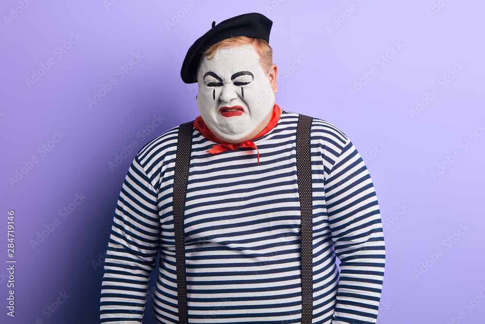 crying mime wearing striped sweater, beret. close up photo. negative feeling and emotion. facial expression crying mime wearing striped sweater, beret. close up photo. negative feeling and emotion. facial expression