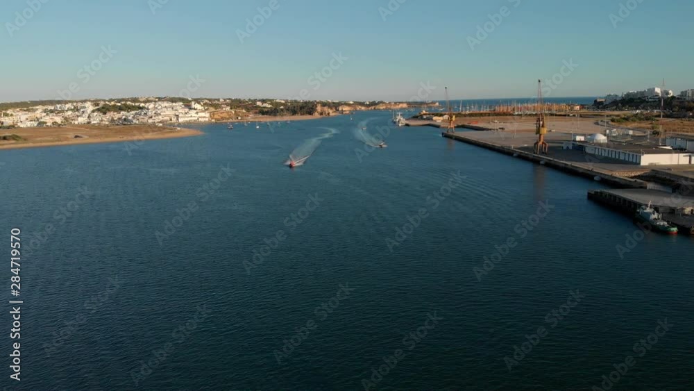 Aerial of fast approaching motor boats on Arade River in Algarve, Portugal Aerial of fast approaching motor boats on Arade River in Algarve, Portugal