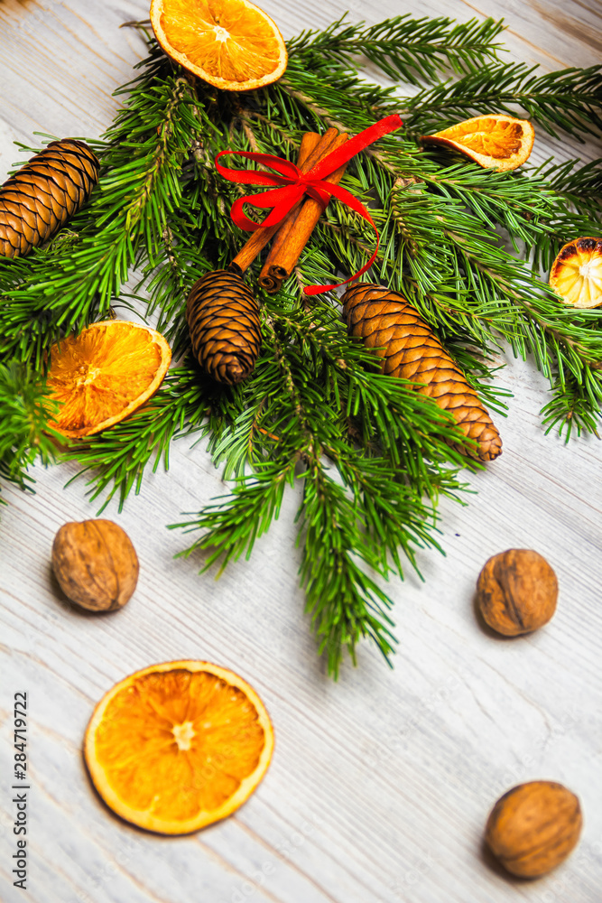 Christmas and New Year composition. Pine branches, cinnamon sticks, dried slices of orange and walnuts. Christmas and New Year concept. Flat lay.