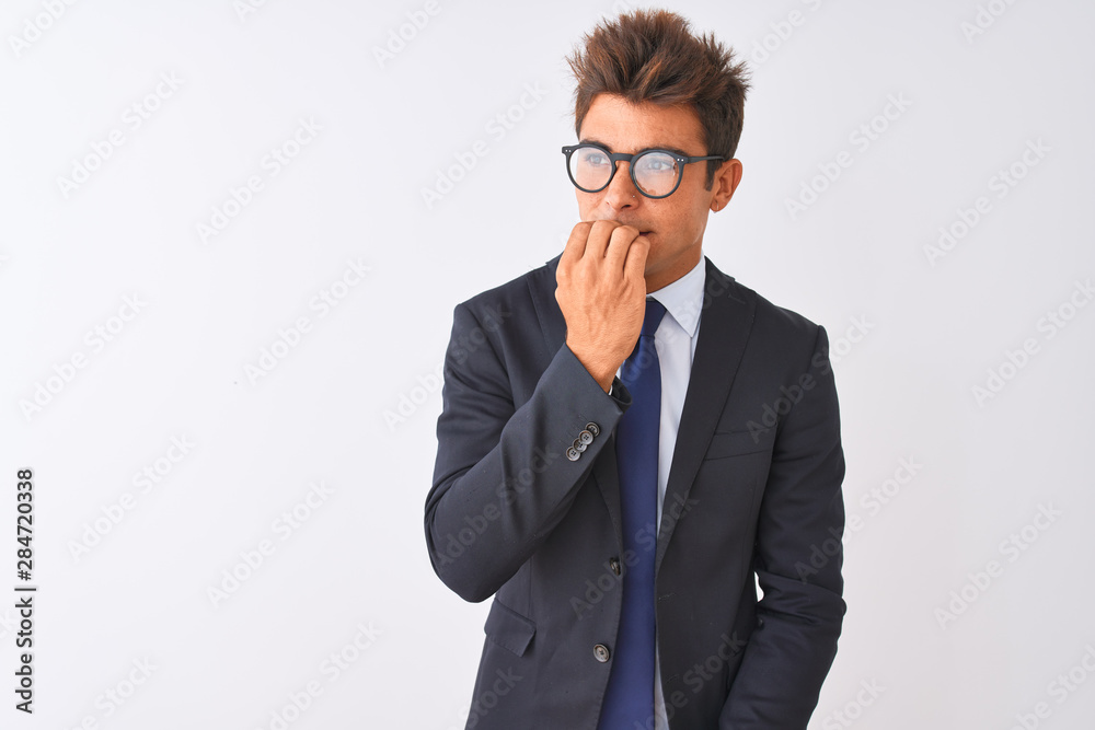 Young handsome businessman wearing suit and glasses over isolated white background looking stressed and nervous with hands on mouth biting nails. Anxiety problem. Young handsome businessman wearing suit and glasses over isolated white background looking stressed and nervous with hands on mouth biting nails. Anxiety problem.