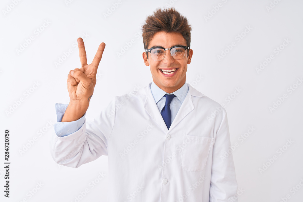Young handsome sciencist man wearing glasses and coat over isolated white background showing and pointing up with fingers number two while smiling confident and happy. Young handsome sciencist man wearing glasses and coat over isolated white background showing and pointing up with fingers number two while smiling confident and happy.