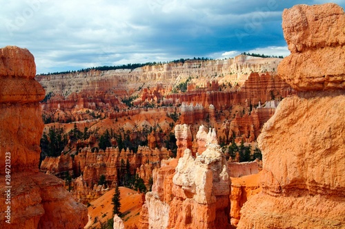 View on valley with red, orange ,white color sedimentary sharp tower like rocks (hoodoos) - Bryce Canyon, Utah, USA