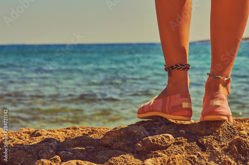 Woman enjoying the view on the sea/ocean. Summer concept.