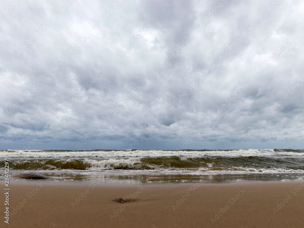 beautiful waves going to the coast, stormy sea with thunder clouds over, beautiful waves going to the coast, stormy sea with thunder clouds over,