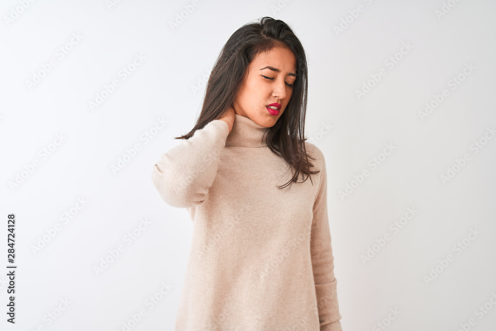 Beautiful chinese woman wearing turtleneck sweater standing over isolated white background Suffering of neck ache injury, touching neck with hand, muscular pain Beautiful chinese woman wearing turtleneck sweater standing over isolated white background Suffering of neck ache injury, touching neck with hand, muscular pain