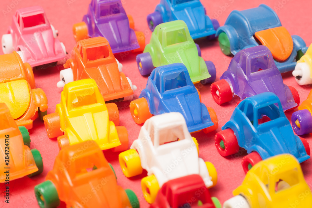 Naklejka premium Toys plastic cars on a red background