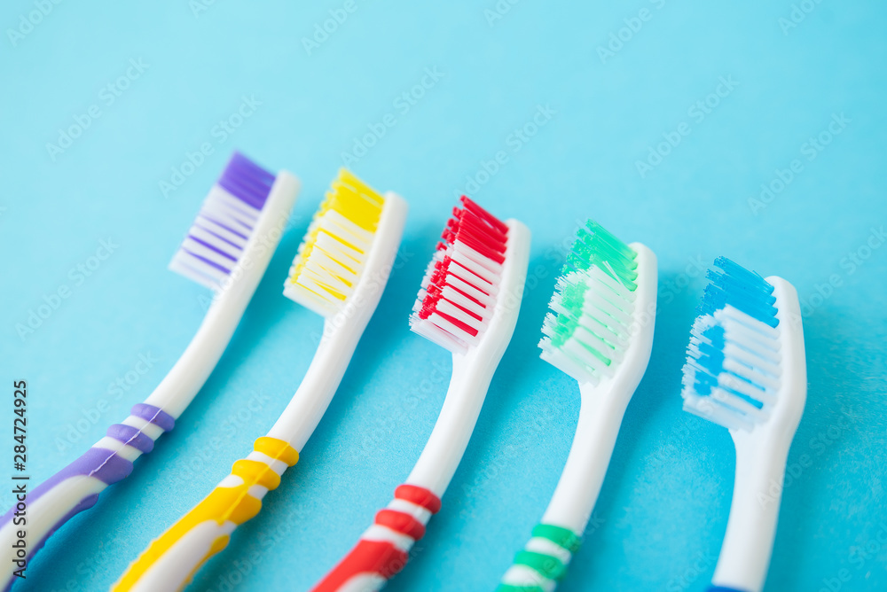 set of plastic toothbrushes on blue background set of plastic toothbrushes on blue background