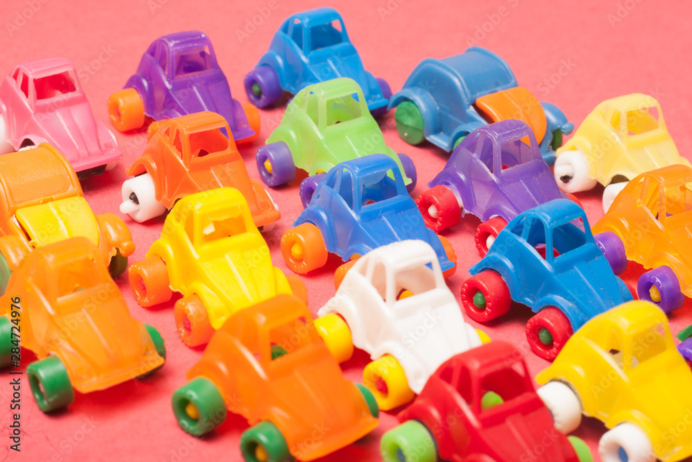 Toys plastic cars on a red background Toys plastic cars on a red background