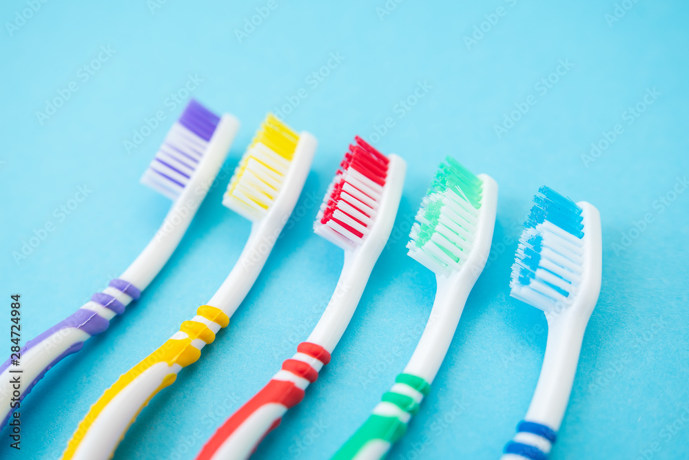 set of plastic toothbrushes on blue background set of plastic toothbrushes on blue background