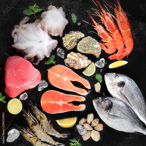 Fresh seafood octopus langoustines Dorada oysters Penaeidae salmon tuna with lemon ice pieces photo