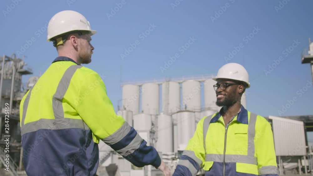 Engineer and inspector shaking hands Engineer and inspector shaking hands