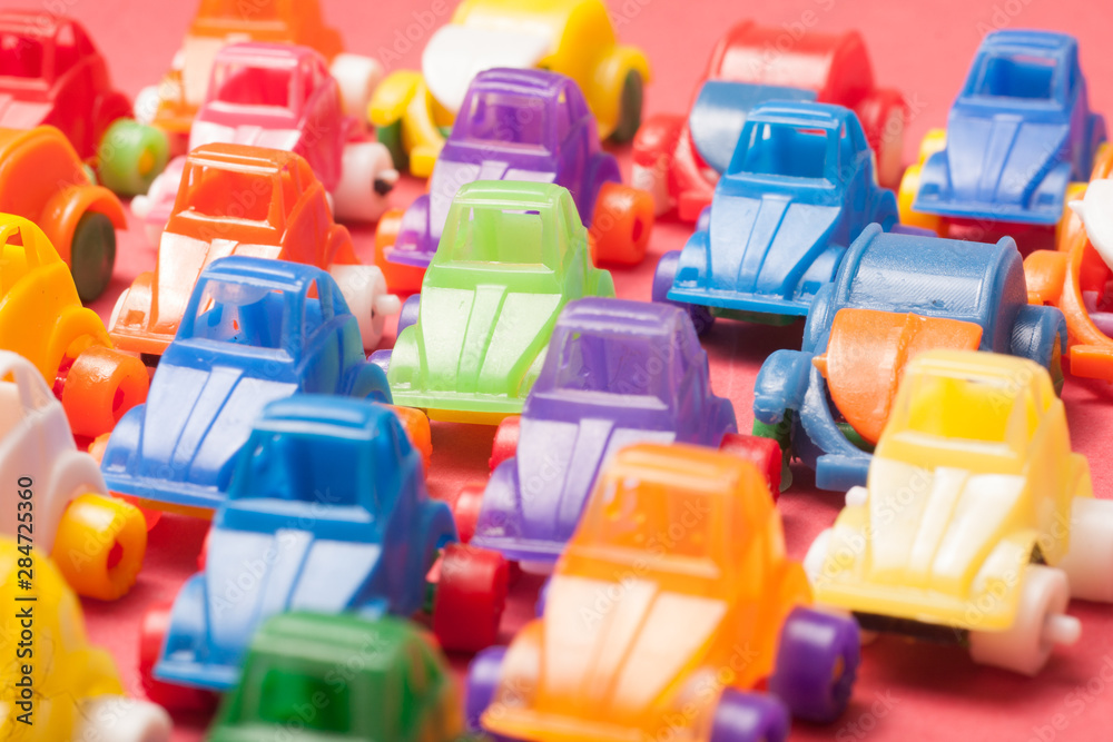 Naklejka premium Toys plastic cars on a red background