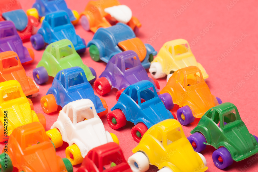 Naklejka premium Toys plastic cars on a red background