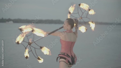 Girl with a torch fire show on the river bank at sunset. slow motion S-Log3, S-Gamut3, Cine