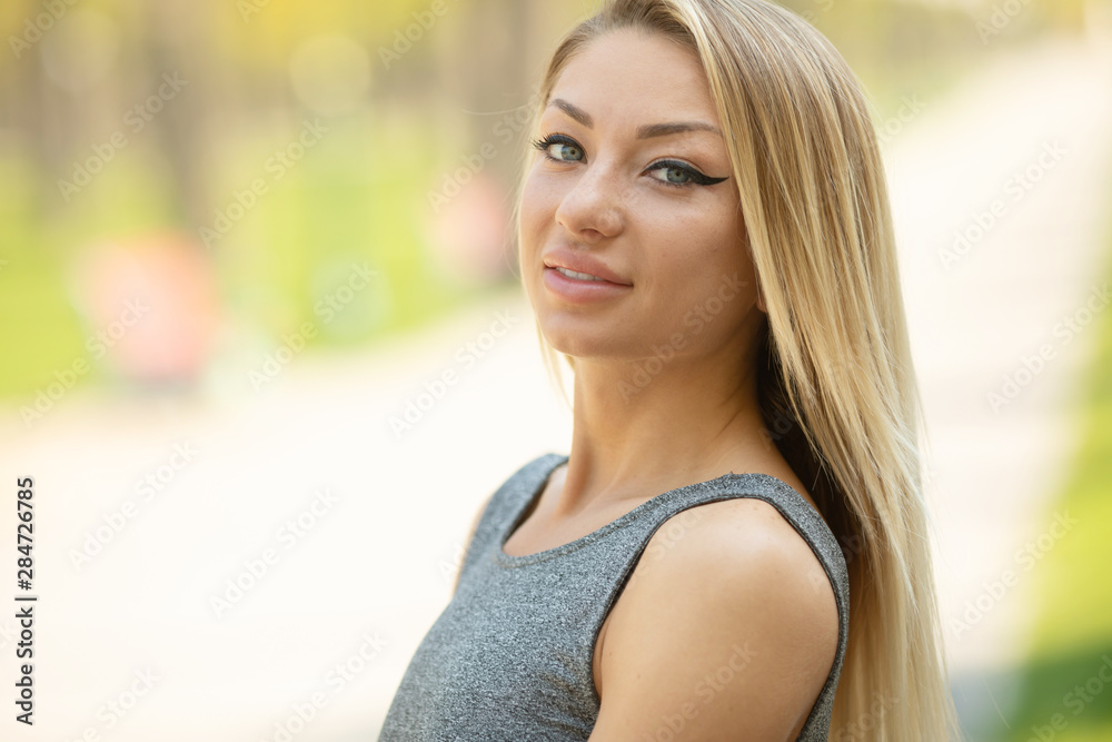Outdoors lifestyle fashion portrait of happy stunning blonde girl. Beautiful smile. Walking to the city street. Joyful and cheerful woman. Happiness Outdoors lifestyle fashion portrait of happy stunning blonde girl. Beautiful smile. Walking to the city street. Joyful and cheerful woman. Happiness