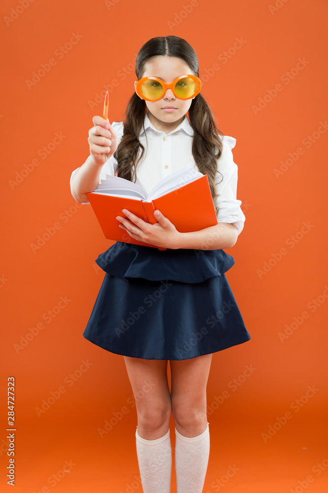 inspiration for writing. get information from book. happy school girl in uniform and party glasses. small child with notebook. literature lesson education. writing in workbook. children literature inspiration for writing. get information from book. happy school girl in uniform and party glasses. small child with notebook. literature lesson education. writing in workbook. children literature