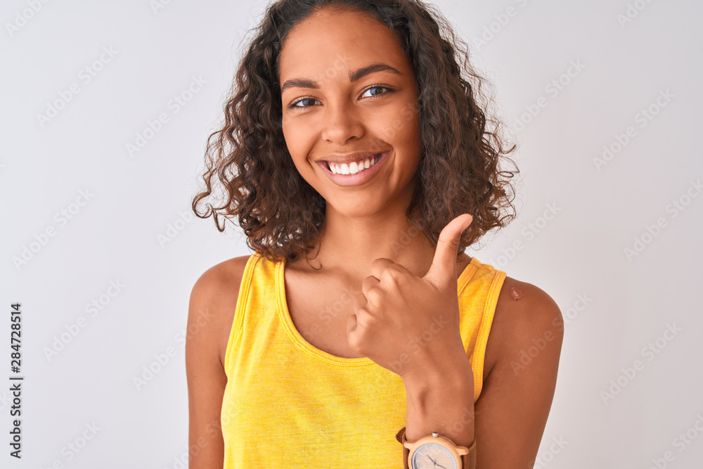 Young brazilian woman wearing t-shirt standing over isolated white background happy with big smile doing ok sign, thumb up with fingers, excellent sign Young brazilian woman wearing t-shirt standing over isolated white background happy with big smile doing ok sign, thumb up with fingers, excellent sign