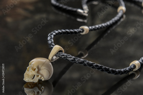 wood and silver jewelry in the shape of a skull