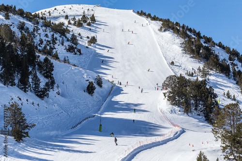 View of a steep ski slope at a winter resort in the Pyrenees, Andorra. photo