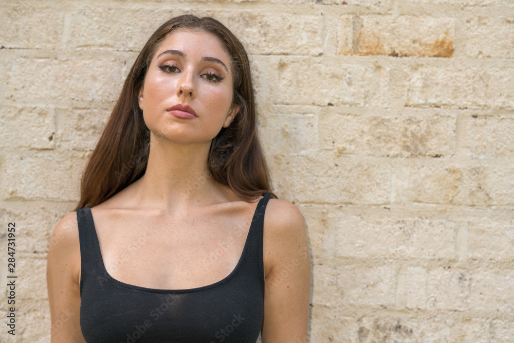 Attractive woman posing in a black tank top shirt Attractive woman posing in a black tank top shirt