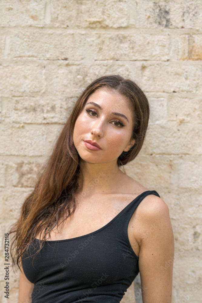 Flirtatious young woman smiling at camera Flirtatious young woman smiling at camera