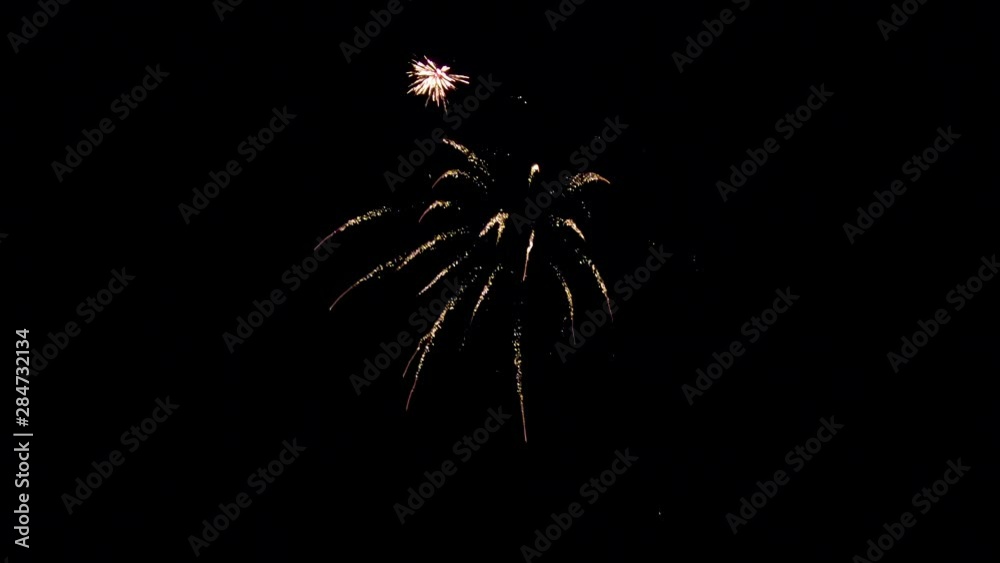 A black sky with fireworks bursting into frame is a beautiful sight. Segment 7 of 8 in slow motion, and is one part of a longer clip when placed together.