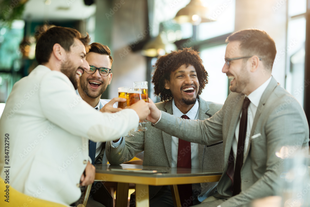 Four male friends are at the bar they are watching game and drinking beer.