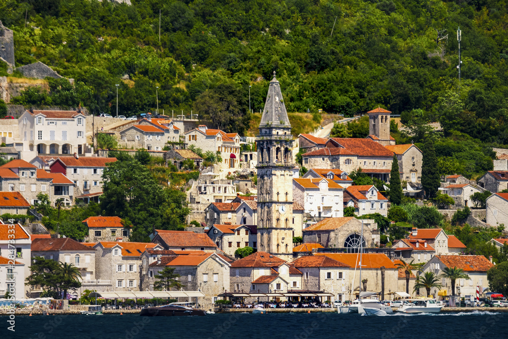 Classic  view of the historic town of Perast located at world-famous Bay of Kotor on a beautiful sunny day with blue sky and Balkan mountains  in summer, Montenegro, southern Europe.