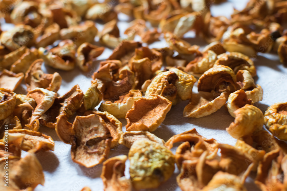 dried fruits apples and pears yellow-brown lie on a white cloth dried fruits apples and pears yellow-brown lie on a white cloth