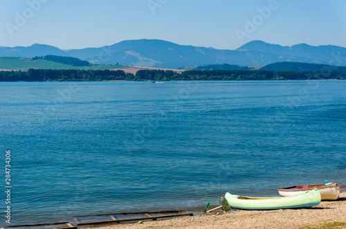 Boats on the beach of Liptovska Mara lake, Slovakia photo