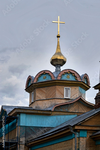 Krestovozdvizhenskaya wooden church on background of blue sky in the village of Demyansk photo