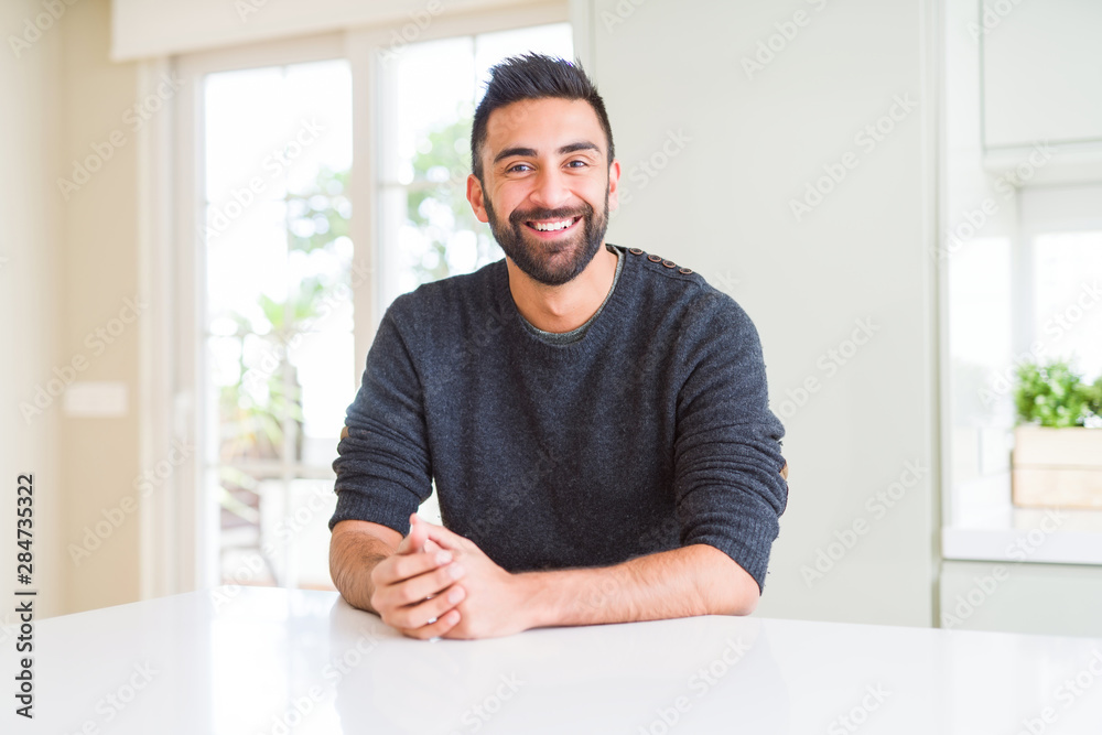Handsome man smiling cheerful with a big smile on face showing teeth, positive and happy expression Handsome man smiling cheerful with a big smile on face showing teeth, positive and happy expression