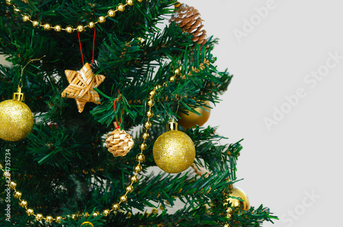 Christmas fir tree with balls and serpentine closeup. White blank background.