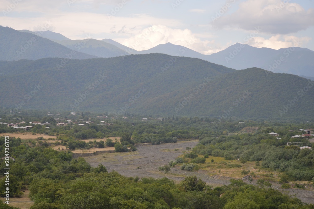 View of the mountain river bed, valley and mountains in the distance